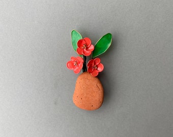 Refrigerator magnet with beach terra cotta pottery from Italy and a bouquet of handmade orange flower.