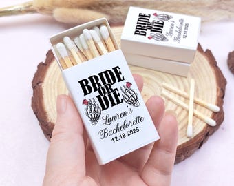 May include: White matchbox with black text that reads "Bride or Die" with a skeleton hand holding a red rose. The matchbox is personalized with the name "Lauren's Bachelorette" and the date "12.18.2025".