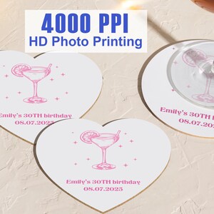 May include: Three heart-shaped coasters with a pink cocktail glass design and the text "Emily's 30TH birthday 08.07.2025".