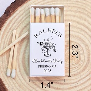 May include: A white matchbox with a black and white illustration of a woman in a martini glass. The text on the box reads "Rachel's Bachelorette Party Fresno, CA 2025". The matchbox is 5.8 cm tall and 3.6 cm wide.