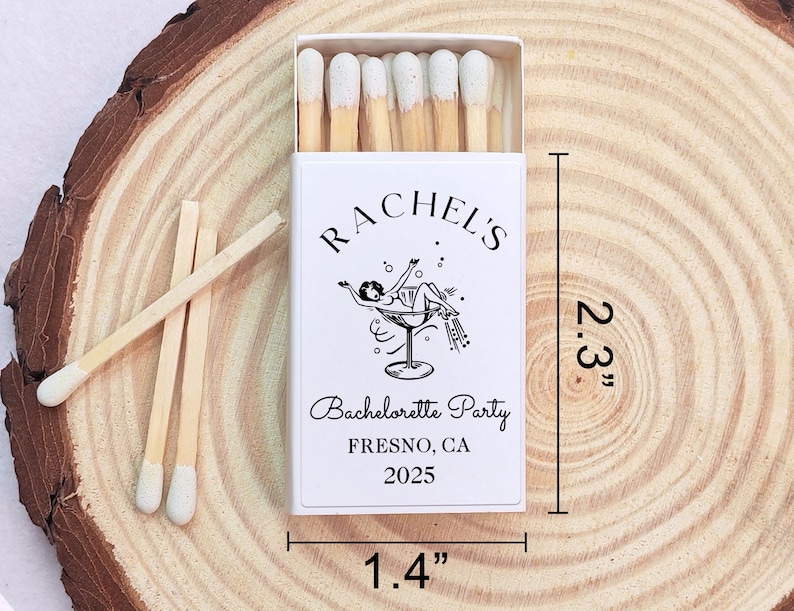 May include: A white matchbox with a black and white illustration of a woman in a martini glass. The text on the box reads "Rachel's Bachelorette Party Fresno, CA 2025". The matchbox is 5.8 cm tall and 3.6 cm wide.