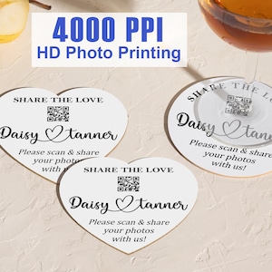 May include: White heart-shaped and circular coasters with the text "SHARE THE LOVE", "Daisy Tanner", and a QR code. The coasters also include the text "Please scan & share your photos with us!" and "4000 PPI HD Photo Printing".