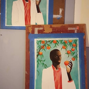 May include: Two framed paintings of a person in a white jacket and a pink shirt holding a peach in front of a green tree with orange peaches.