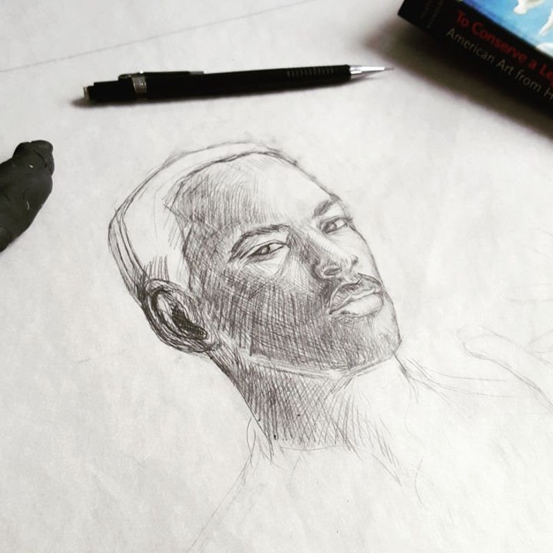 May include: A pencil drawing of a person's face. The person has short hair and is looking directly at the viewer. The drawing is done in shades of gray.