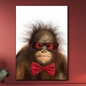 May include: A portrait of an orangutan wearing red-tinted sunglasses and a red bow tie. The orangutan has brown fur and is centered against a white background. The image is a print, likely a canvas, and is displayed in a living room.
