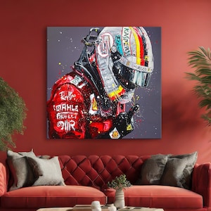 May include: A large square canvas art piece depicting a Formula 1 driver's helmet and racing suit. The artwork features a vibrant color palette with red, black, white, and yellow accents. The helmet displays sponsor logos and a colorful design. The racing suit has sponsor logos.