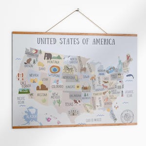 May include: A framed map of the United States of America. The map is illustrated with colourful icons representing each state. The text "UNITED STATES OF AMERICA" is at the top. The frame is made of wood and is hanging from a string.