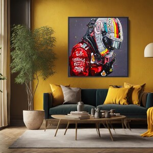 May include: A framed artwork depicts a Formula 1 driver in a helmet and racing suit. The helmet features a colorful design, and the suit is red with sponsor logos. The artwork is displayed in a living room setting.
