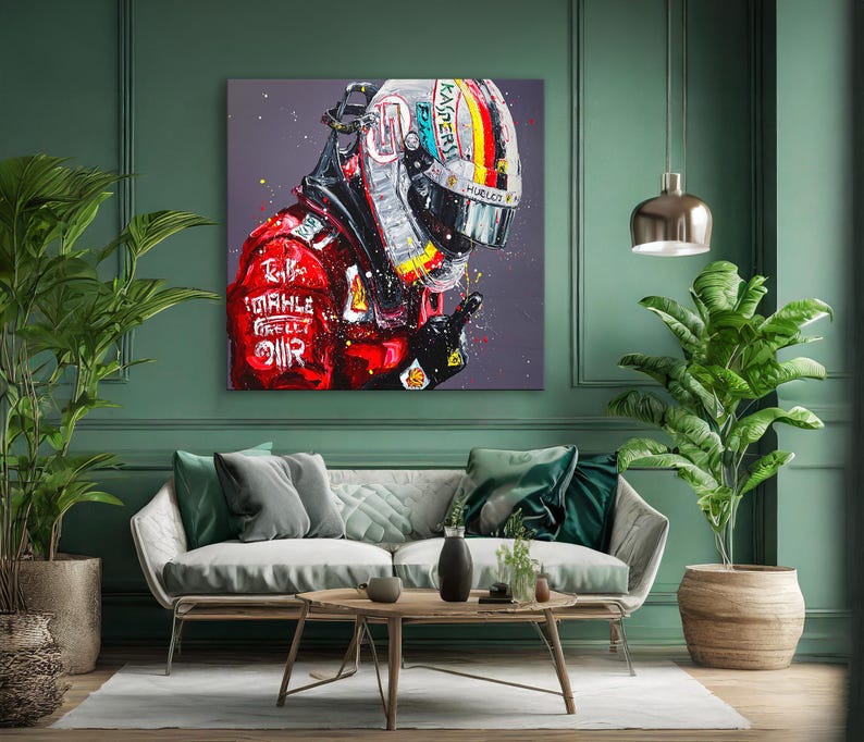 May include: A vibrant painting of a racing helmet and suit. The helmet features a colorful design with the word "KASPER" and the suit has the word "MAHLE" printed on it. The artwork is displayed on a green wall above a sofa.