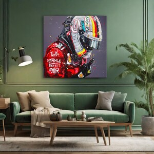 May include: A vibrant painting of a Formula 1 driver in a red racing suit and helmet. The artwork features bold brushstrokes and a dynamic composition, with the driver's helmet displaying a colorful design. The painting is displayed above a green sofa.