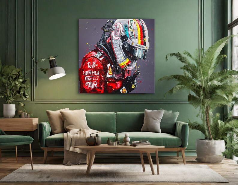 May include: A vibrant painting of a Formula 1 driver in a red racing suit and helmet. The artwork features bold brushstrokes and a dynamic composition, with the driver's helmet displaying a colorful design. The painting is displayed above a green sofa.