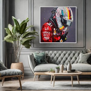 May include: A framed artwork depicts a Formula 1 driver in a red racing suit and helmet. The helmet features a colorful design with the number 1. The artwork is displayed above a gray tufted sofa in a living room setting.
