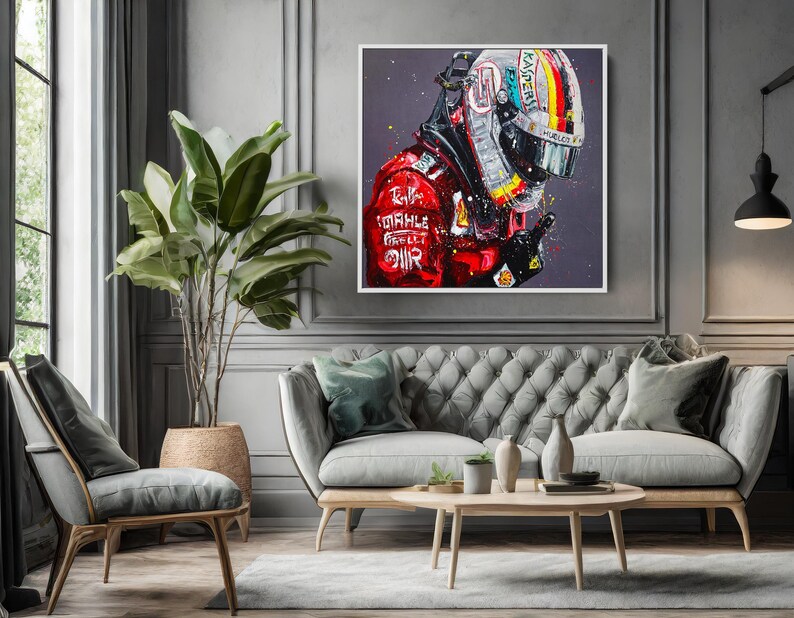 May include: A framed artwork depicts a Formula 1 driver in a red racing suit and helmet. The helmet features a colorful design with the number 1. The artwork is displayed above a gray tufted sofa in a living room setting.