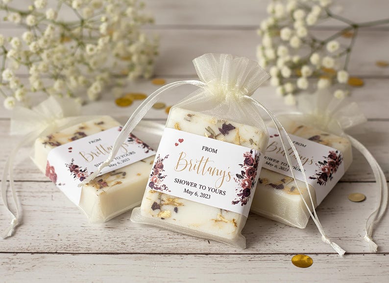 Bridal shower and wedding soap favors.  Custom designed favors with a gold mica swirl top and dried botanicals, personalized label and ivory organza bags.