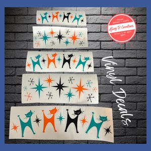 May include: Vinyl decals featuring mid-century modern designs. The decals include stylized cat silhouettes in teal, orange, and black, along with starburst and star accents. The text "Vinyl Decals" is visible.