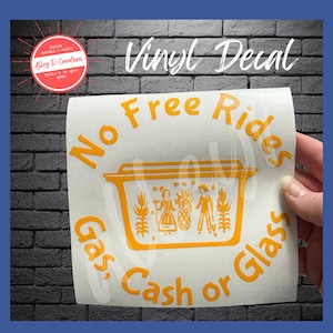 May include: A yellow vinyl decal with the text "No Free Rides Gas, Cash or Glass" and a stylized image of a yellow casserole dish with two figures inside.