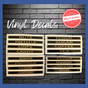 May include: Set of 10 vinyl decals for kitchen canisters. The decals are black with gold lettering and include the words "Nuts", "Pretzels", "Chips", "Candy", "Flour", "Sugar", "Coffee", and "Tea".
