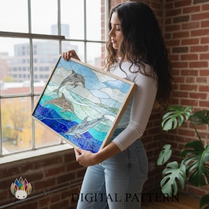 May include: A framed stained glass panel featuring dolphins swimming in the ocean. The artwork uses shades of blue, teal, and white to depict the water and sky. The frame is made of light-colored wood. The words "DIGITAL PATTERN" are visible.