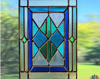 May include: A stained glass window panel with a geometric design featuring blue, green, and white glass pieces. The panel is framed in a copper-toned metal.