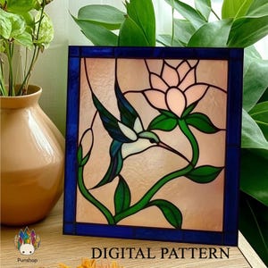May include: Stained glass panel featuring a hummingbird and a flower. The bird has blue and green wings, a white body, and a long beak. The flower is pink, and the leaves are green. The panel is framed in blue and has the text "DIGITAL PATTERN".