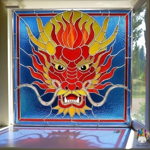 Può includere: Una vetrata raffigurante una testa di drago rossa, gialla e arancione su sfondo blu. Il drago presenta dettagli intricati, tra cui denti affilati e baffi fluenti. La finestra è incorniciata da un bordo rosso e blu.