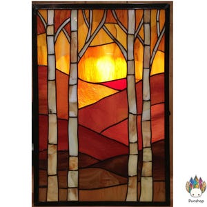May include: Stained glass panel showing a sunset scene with birch trees. The artwork uses a vibrant palette of orange, red, and yellow, with the trees in shades of white and brown. The panel is framed in black.