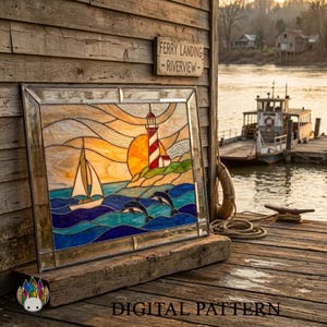 May include: A rectangular stained glass panel featuring a sailboat on blue waves, two leaping dolphins, and a red and white striped lighthouse against a yellow sun. The piece is framed in clear glass and displays the text DIGITAL PATTERN.