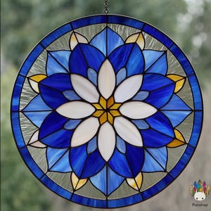May include: Round stained glass window with a floral pattern. The design includes a central white flower with a yellow core, encircled by blue and light blue petals. The outer ring is a mix of blue, yellow, and clear glass.
