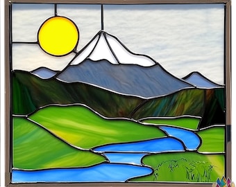 May include: A stained glass window depicting a mountain range with a bright yellow sun in the sky. A blue river winds through the green valley below the mountains.