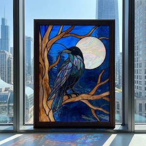 May include: A rectangular stained glass panel in a dark wood frame depicting a black raven perched on a brown tree branch against a deep blue night sky with a large, iridescent white full moon. The glass features varied textures and colours.