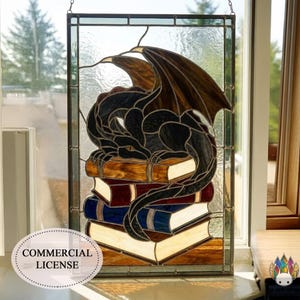 May include: Stained glass panel depicting a black dragon on a pile of books. The dragon has brown wings and is set against a clear background. The books are in shades of brown, red, and blue. The words "COMMERCIAL LICENSE" are in the lower left.