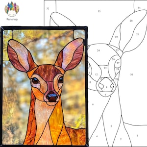 May include: A stained glass art piece depicting a close-up of a fawn's face. The fawn's fur is a mix of brown, orange, and yellow. The background is a blurry image of fall foliage.