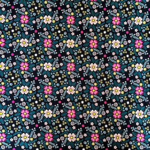 May include: Black fabric with a repeating pattern of pink, white, and yellow flowers with green leaves. The fabric has a subtle shimmer.