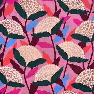 May include: A pink floral fabric with a repeating pattern of white and gold flowers, dark green leaves, and stems. The design includes accents of red, blue, and pink leaves, creating a vibrant and colorful textile.