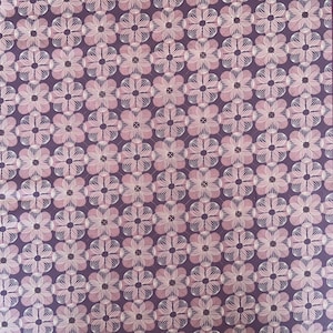 May include: Purple fabric with a white floral pattern. The flowers are made up of overlapping circles and lines.