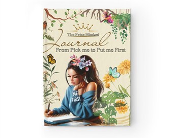 May include: A journal cover with a floral design and a woman writing in a journal. The text on the cover reads "The Prize Mindset Journal From Pick me to Put me First".