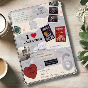 May include: A clear tablet case with a collage design featuring the text "I ❤️ Joey Lynch", book covers, and handwritten notes. The case includes a red heart, a green circular emblem, and the number "6".