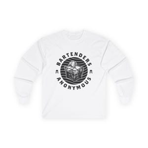 May include: White long-sleeve shirt featuring a black and white graphic. The graphic is a circular design with the text "BARTENDERS ANONYMOUS" around a detailed illustration of a cocktail with ice cubes. Two skull and crossbones symbols flank the design.