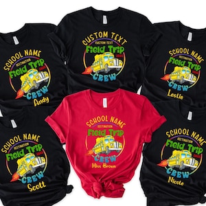 May include: Six black t-shirts with a yellow school bus graphic and the text "School Name Destination Field Trip Crew" with different names below. One red t-shirt with the same graphic and the text "School Name Destination Field Trip Crew Miss Brown".
