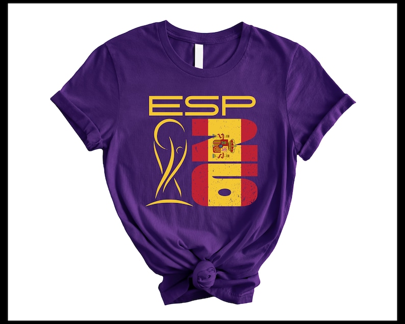 May include: A purple t-shirt with a graphic design featuring the letters "ESP" in yellow, the number "2016" in red and yellow, and a gold emblem. The shirt is knotted at the bottom.