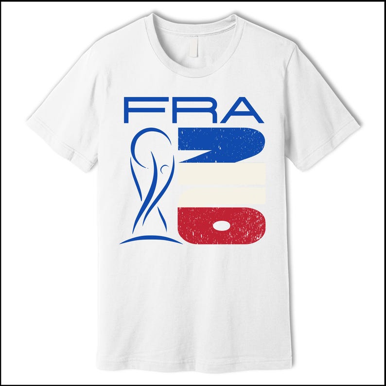 May include: White t-shirt featuring a graphic design with the word "FRA" in blue, a blue and white design, and a red and white design. The shirt also includes a blue graphic of a trophy.