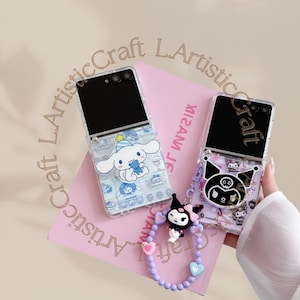 May include: Two clear phone cases with cartoon character designs. One case features a white dog-like character with a blue hat and a blue bear. The other case has a black and white character with a bow. A pink book is in the background.