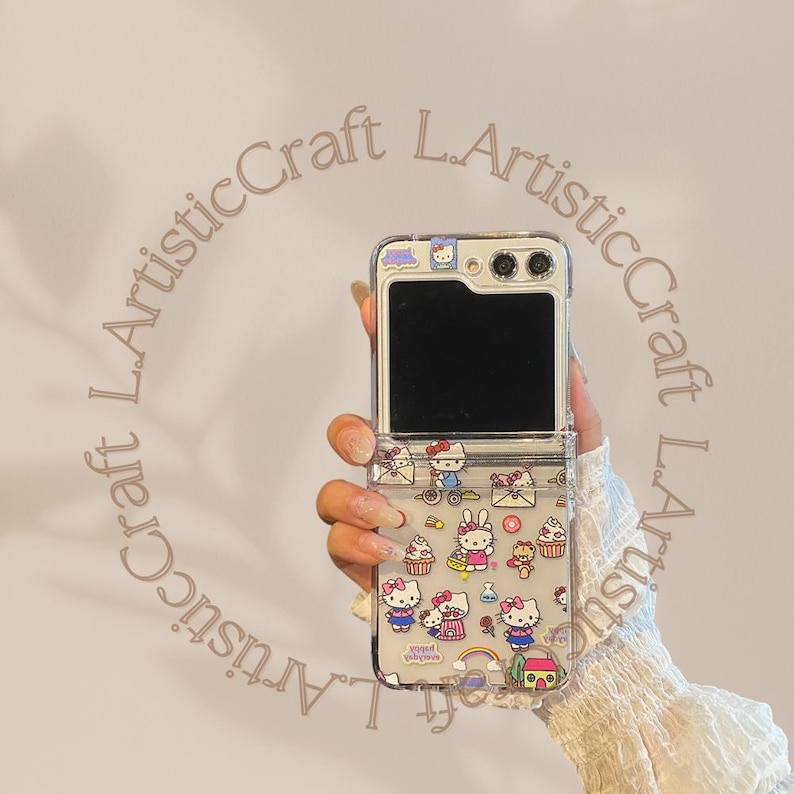 May include: A clear phone case with a Hello Kitty design. The case has a flip-up cover that reveals a black screen. The case is decorated with Hello Kitty characters, hearts, and other cute designs.