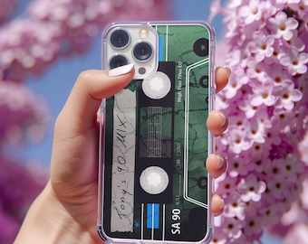 May include: A green and black cassette tape phone case with the text "Tony's 90 Mix" written on it. The case has a clear back and a black border.