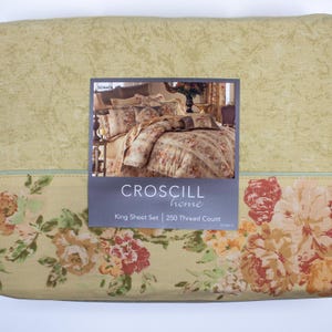 May include: A king sheet set with a floral pattern in shades of cream, green, and red. The packaging displays the brand name "Croscill home" and the text "250 Thread Count". The overall design is a classic, romantic style.