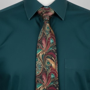 May include: A solid dark teal button-down shirt with a pointed collar and a chest pocket, paired with a necktie featuring a complex, swirling pattern in shades of deep red, gold, and teal against a dark background, tied in a standard knot.