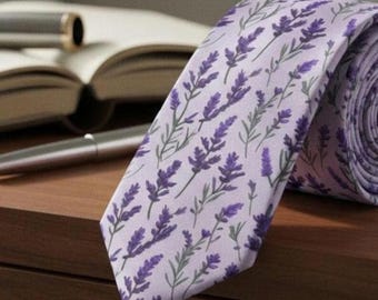 May include: A necktie featuring a light purple background with a repeating pattern of dark purple lavender sprigs and green stems. The fabric has a smooth texture and the tie is folded into a roll at the right side, showing the pointed end.