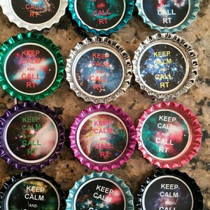 May include: Twelve bottle caps with a galaxy background and the text "Keep Calm and Call RT" in pink and green lettering.