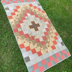 A patchwork textile blanket made of natural fabric in the living room or children&#39;s room