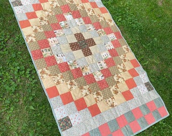A patchwork textile blanket made of natural fabric in the living room or children's room